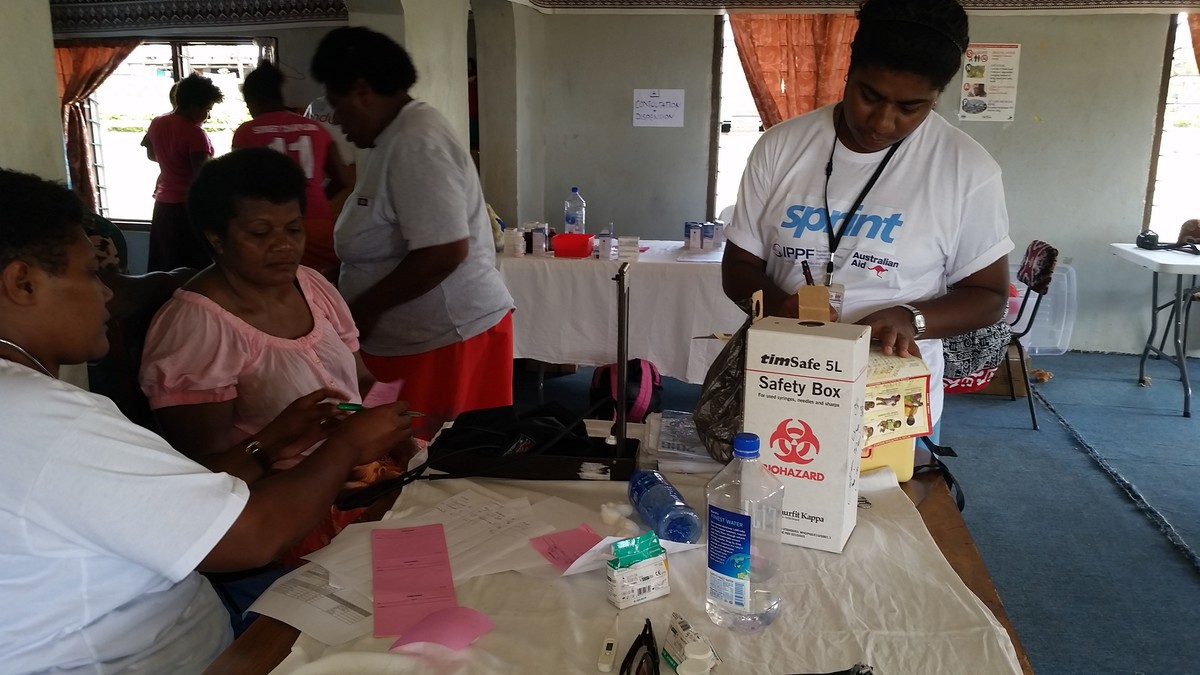 Distributing essential kits to people at the camp