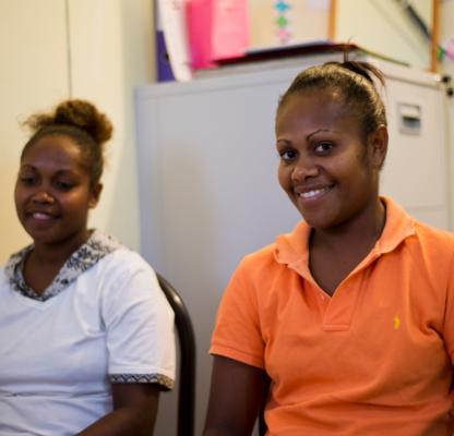 Two girls smiling. Vanuatu Family Health Association 