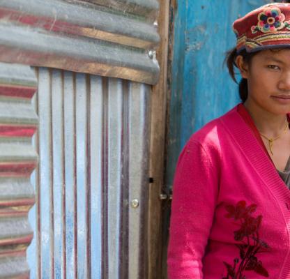 Young woman outside her home in Nepal. 