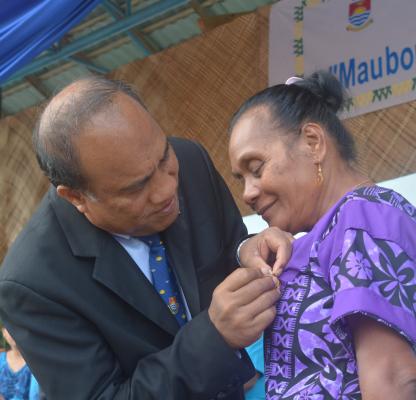 Norma Yeeting receiving her award from President Taneti Mamau
