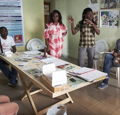 A group of peer educators giving a lesson on contraception and sexual health in Cameroon