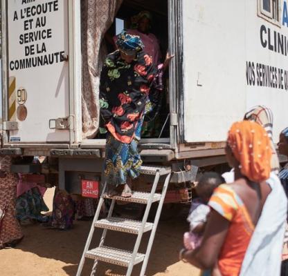 A woman exits the AMPPF mobile clinic