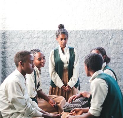 A peer educator in Ethiopia speaks with other young people