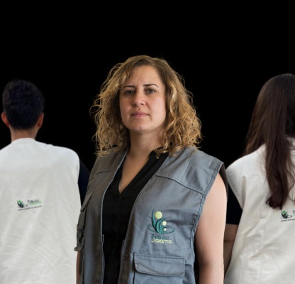 A portrait of Lina Sabra standing with volunteers.