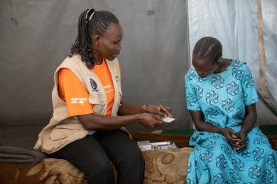 A humanitarian worker assists a client in South Sudan