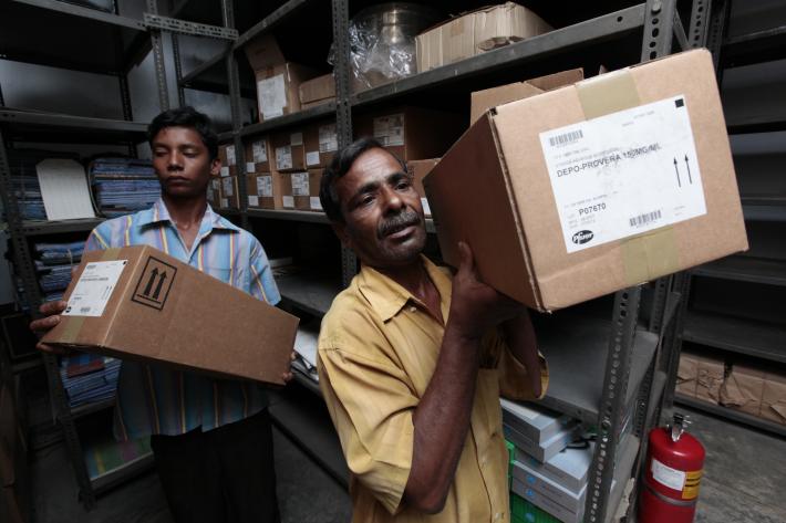 Warehouse workers transporting contraceptive commodities in Bangladesh