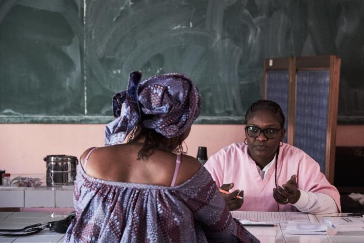 Midwife Ndoye Yacine Touré speaks with client Maguette Mbou, 33, during a free consultancy by ASBEF at School Seydina Limamou Laye in Dakar, Senegal. 