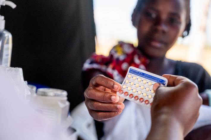 Woman receiving contraceptive pills after Cyclone Idai, Mozambique 