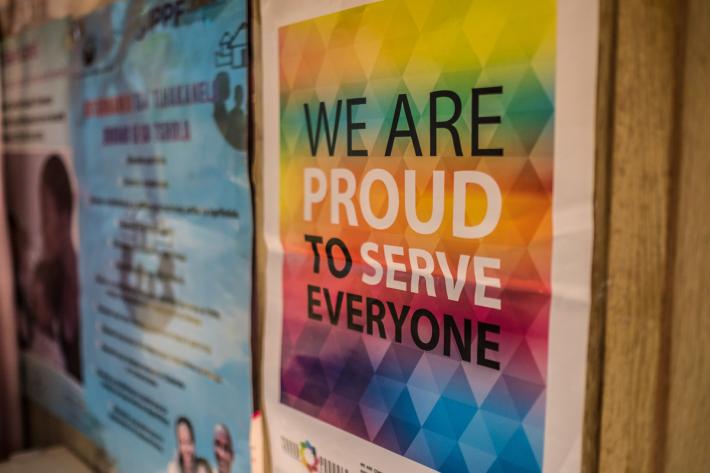 a poster in a clinic stating 'we are proud to serve everyone'