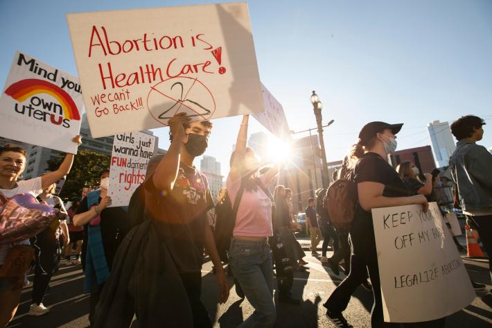 Protestors march with banners against abortion restrictions in the US