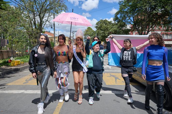 Members of the LGBTQI+ community walk towards the camera in Colombia. They are happy and celebratory. 