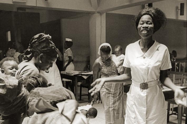 Family planning nurse answering questions at a meeting. Nigeria, 1969