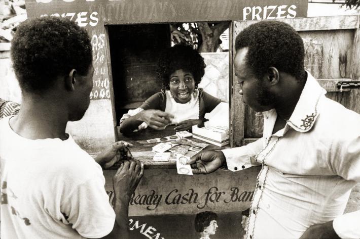 Distributing condoms at a lottery kiosk in Accra. Ghana, 1976
