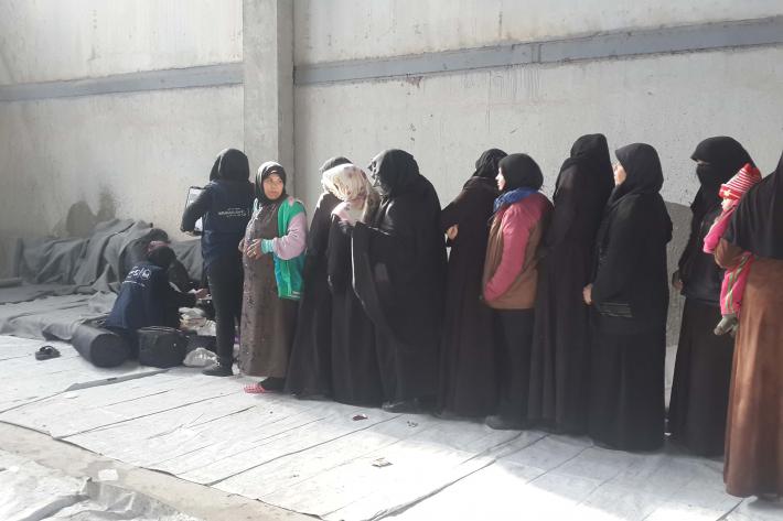 Women are queuing to get assistance. 