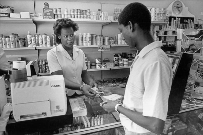 Young man buying contraception supplied by the BFPA to a local supermarket in St James. Barbados 1987