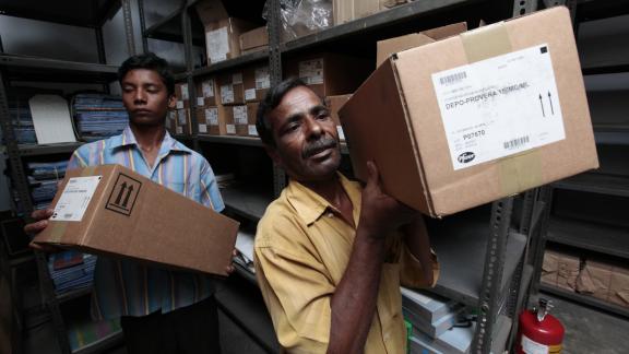 Warehouse workers transporting contraceptive commodities in Bangladesh