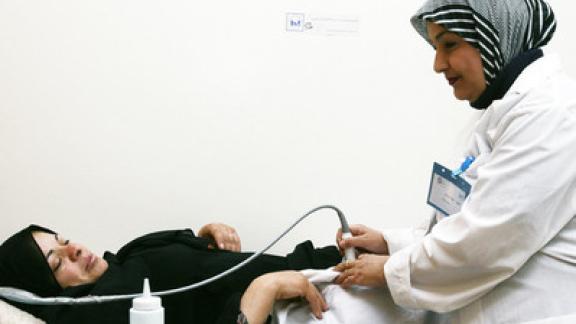 staff performing check up on woman