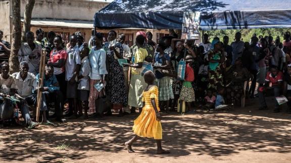 Queues of children, men and women wait in line at a clinic in Gulu, Uganda