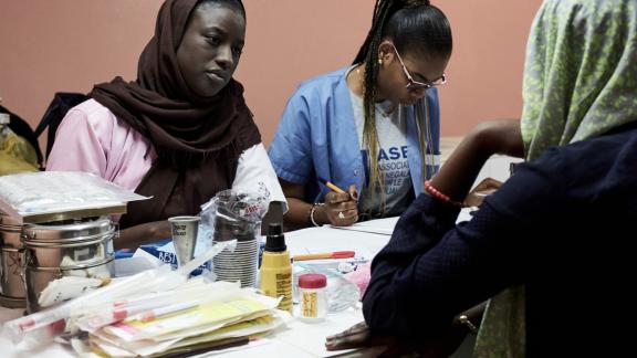 A midwife talks to a client in Senegal 