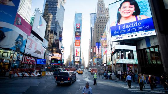 An digital billboard in Times Square reading: "I decide the size of my family"