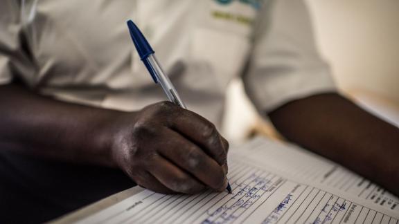 Healthcare worker writing