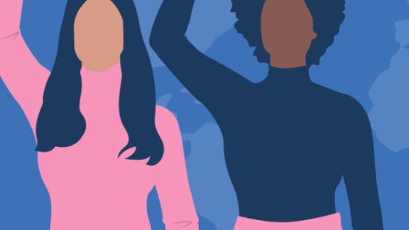 two women raising their fists in the air 