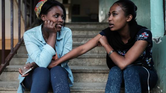 Two young women supporting each other in Ethiopia