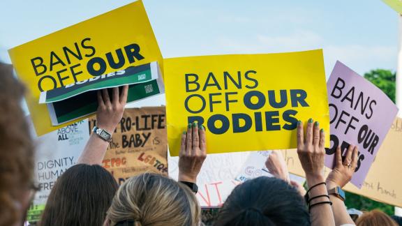 Protest sign reads "bans off our bodies"