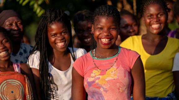 Image of women and girls in Mozambique smiling.
