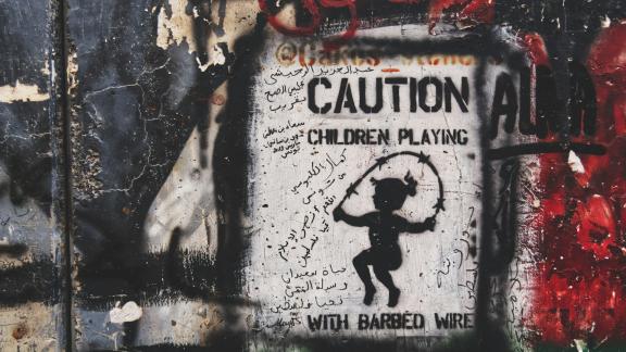 Photo of mural with Caution Children playing text