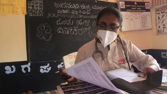A medical worker reviewing paperwork. 