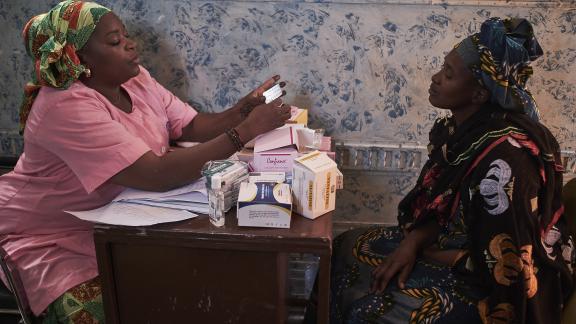 Villager Kaddiatou Sogoba gets treatment from service provider and midwife Mariame Doumbia at the mobile clinic in Missala village outside Bamako, Mali.