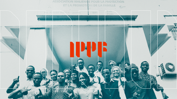 A group of people sit together with the IPPF logo in red place on the image above them.