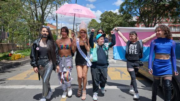 Members of the LGBTQI+ community walk towards the camera in Colombia. They are happy and celebratory. 