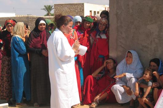 Clinic outreach worker with group of women in Tunisia