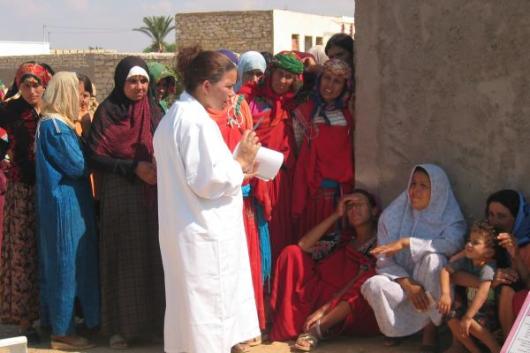 Clinic outreach worker with group of women in Tunisia